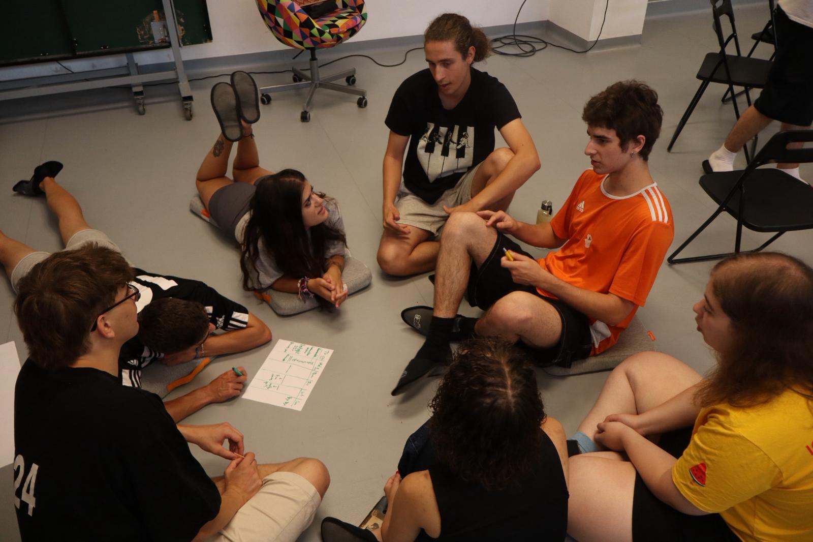 Participants co-creating on the floor in mixed international teams